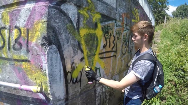 Benjamin Hannam spray painting graffiti (Metropolitan/PA)