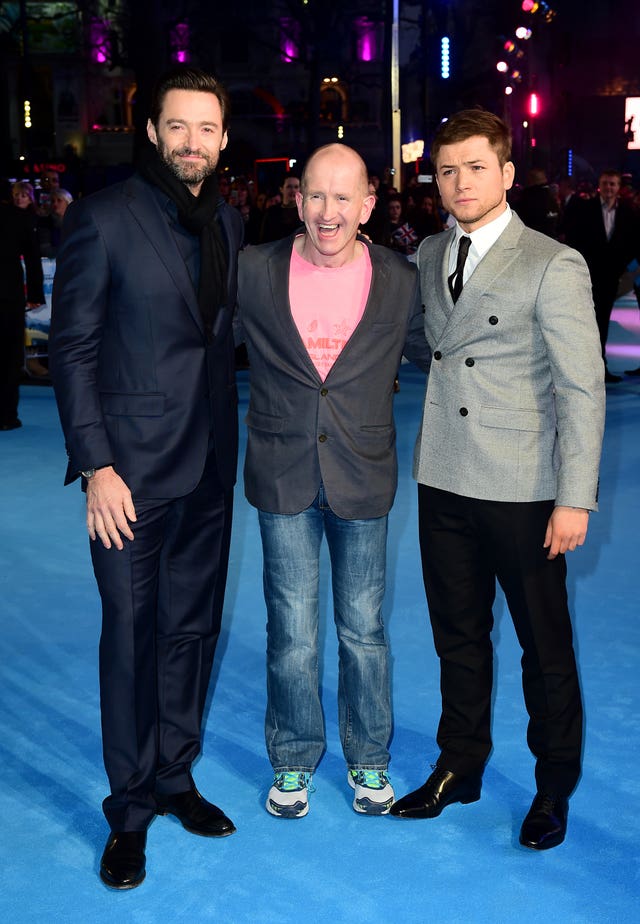 Hugh Jackman, left, Eddie Edwards, and Taron Egerton