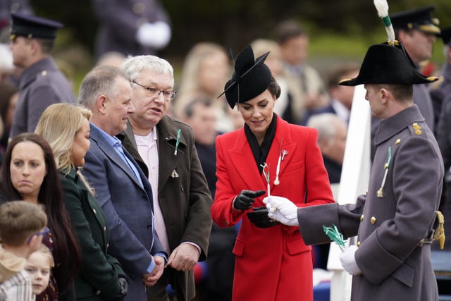 The Princess of Wales presents leeks to members of the public during the St David’s Day visit