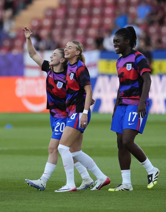 England substitutes Jess Park, Chloe Kelly and Michelle Agyemang, left to right, warm up ahead of Euro 2025 quarter-final against Sweden