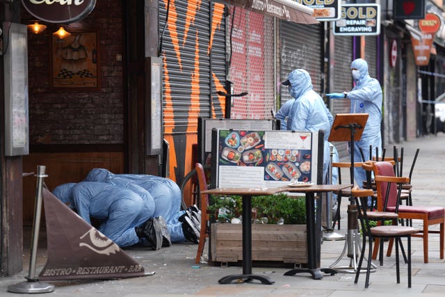 Police forensic officers at the scene in Kingsland High Street