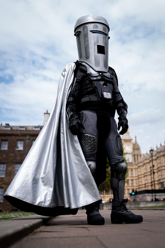 A man standing in fancy dress dressed as an alien called Count Binface outside the Houses of Parliament