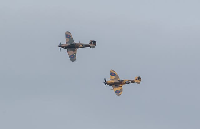 A Battle of Britain Memorial Flight flypast of a Spitfire and a Hurricane passes over the home of Second World War veteran Captain Tom Moore as he celebrates his 100th birthday (Joe Giddens/PA)