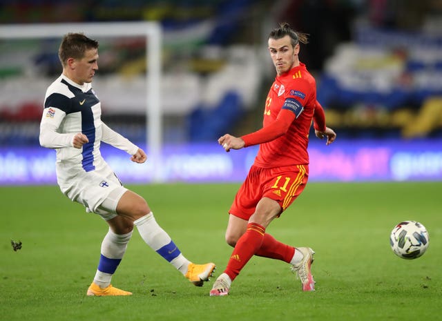 Finland's Robin Lod and Gareth Bale battle for the ball in Cardiff