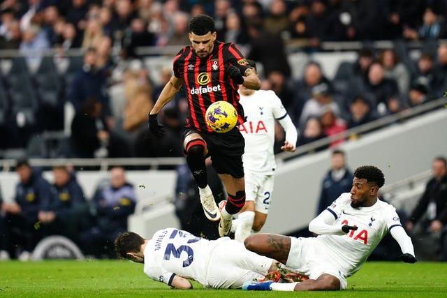 Dominic Solanke (centre) tackled by Tottenham’s Ben Davies (left) and Emerson 