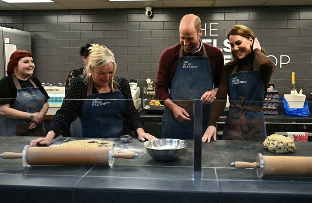 The Prince and Princess (second right) of Wales help prepare and cook a batch of Welsh cakes at The Welsh Cake Shop as shop owner Theresa Connor (centre), looks on, during a visit to Pontypridd Market in Wales to talk to local business owners about the impact of the flooding caused by Storm Bert and Storm Darragh