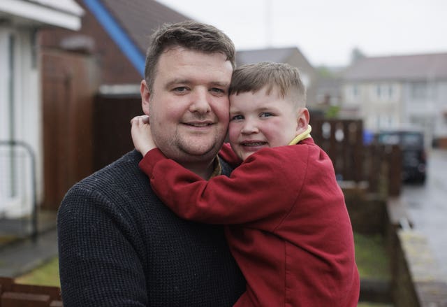 Mairtin Mac Gabhann holding his son Daithi (Liam McBurney/PA)