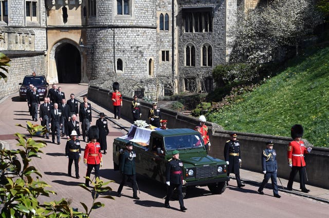 The Land Rover Defender carrying the coffin of the Duke of Edinburgh is followed by members of the royal family