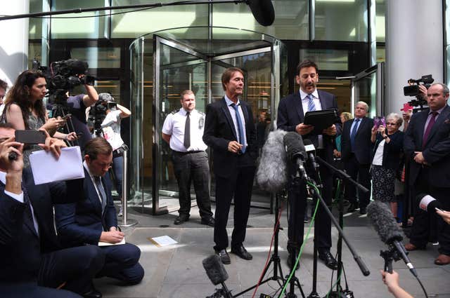 Sir Cliff Richard with lawyer Gideon Benaim outside the Rolls Building in London