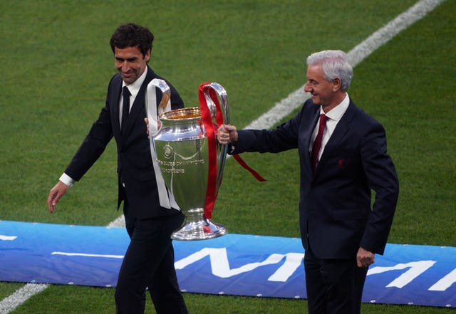 Ian Rush and Raul carry the trophy out 
