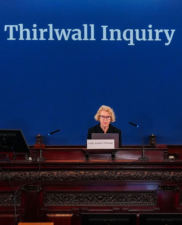 Lady Justice Thirlwall sitting behind at a desk