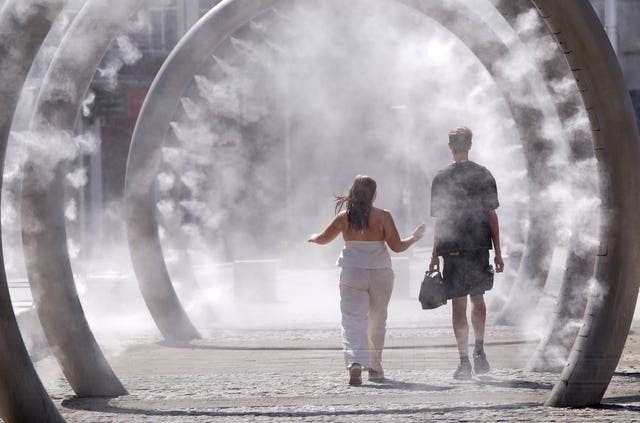Couple walk through feature spraying mist