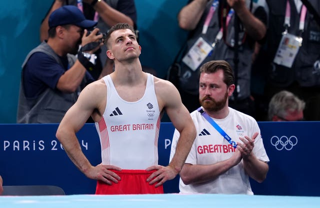 Max Whitlock, left, shows his disappointment during the pommel horse final