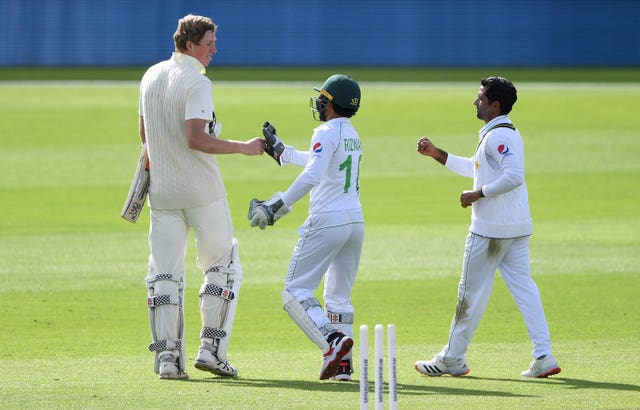 Crawley (left) bumps fists with Pakistan's Mohammed Rizwan 