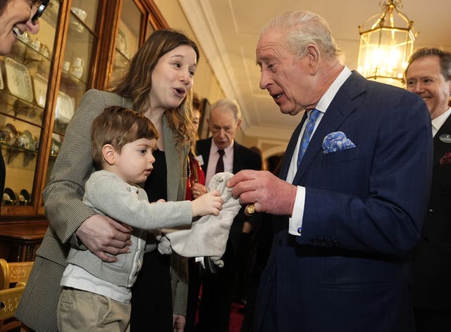 The King meets a young boy at the reception