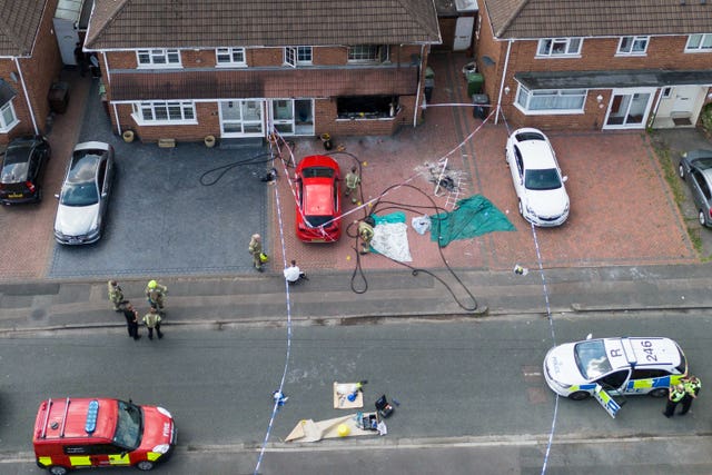 View from above of a house with blackened windows damaged by fire