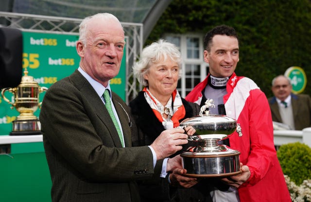  Willie Mullins poses with the Champion Trainer trophy alongside wife Jackie Mullins and son Patrick Mullins