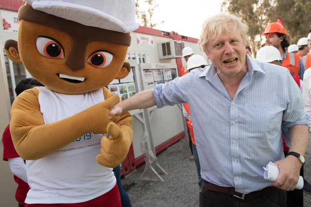 Boris Johnson meets the mascot of the 2019 PanAmerican Games at the athletes’ village in Lima, Peru, which is being built with help from UK construction firms (Stefan Rousseau/PA)