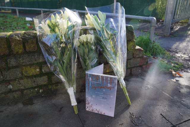 A card and flowers left near the scene 