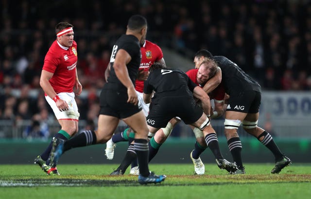 Alun Wyn Jones is tackled by New Zealand's Sam Whitelock and Jerome Kaino