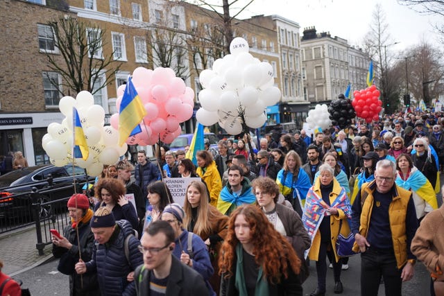 Crowds of people marching to the Russian embassy in London