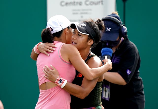 Heather Watson, right, hugs China's Zhang Shuai after her retirement at Birmingham 