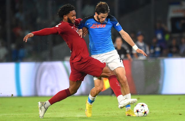 Liverpool’s Joe Gomez (left) and Napoli’s Khvicha Kvaratskhelia in action (Agostino Gemito/PA).