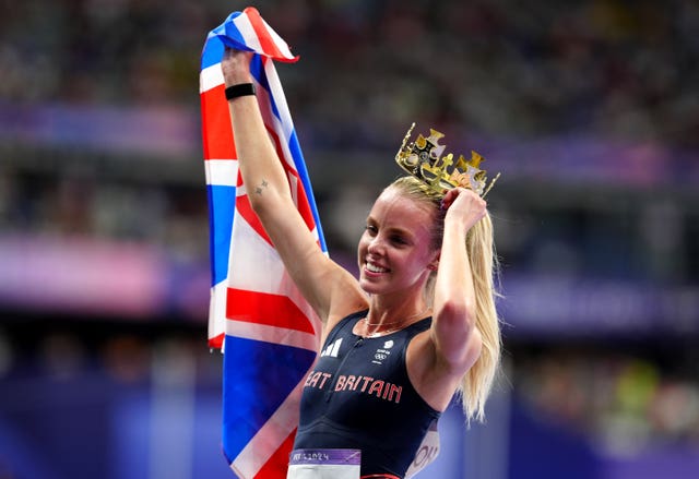 Hodgkinson wearing a crown and holding up a Union Jack after winning gold in Paris