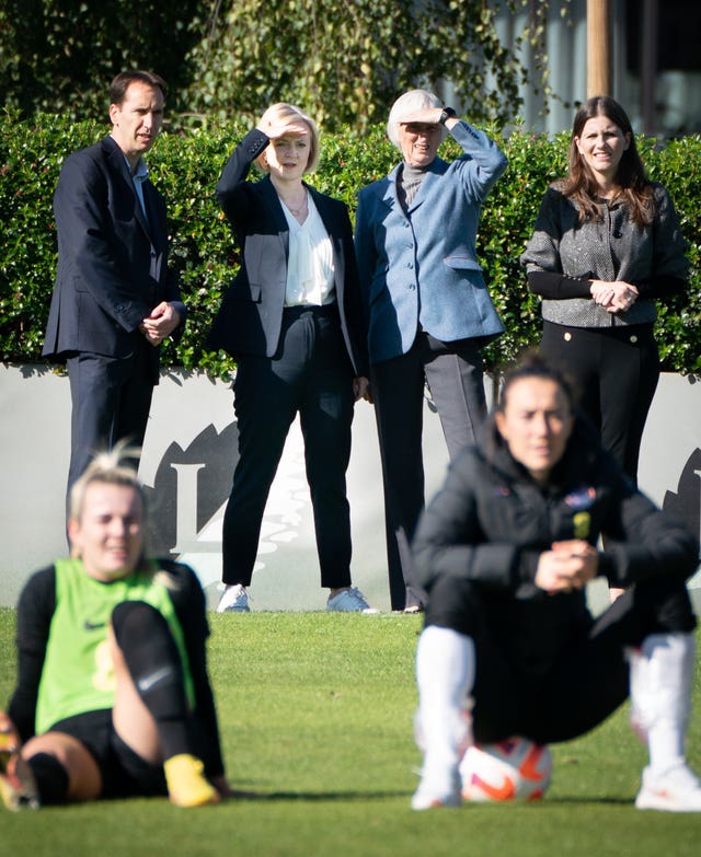 Prime Minister Liz Truss (centre) and Sport Secretary Michelle Donelan MP (far right) watch the England women’s football team training