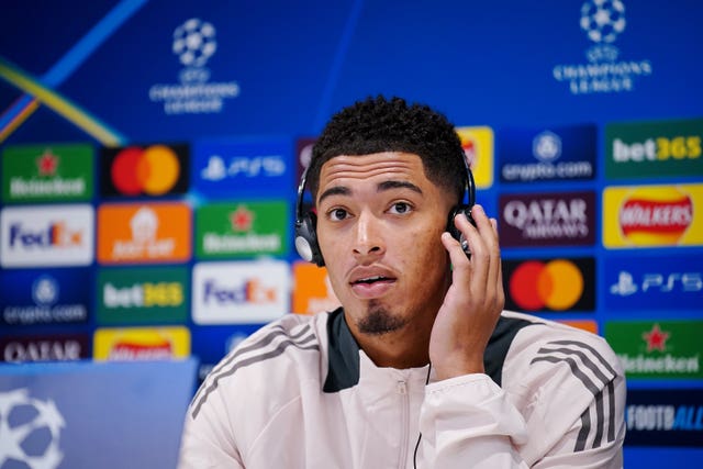 Jude Bellingham touches his ear during a Real Madrid press conference at Anfield