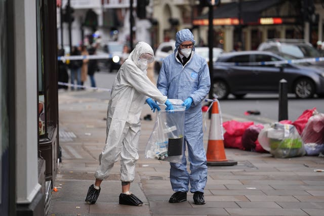 Forensic investigators collect evidence at the scene 