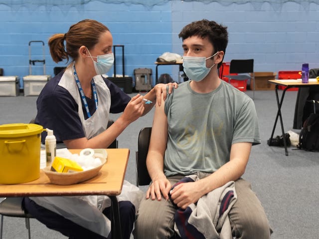 Postgraduate law student Oliver Contreras, from Brighton, receives an injection