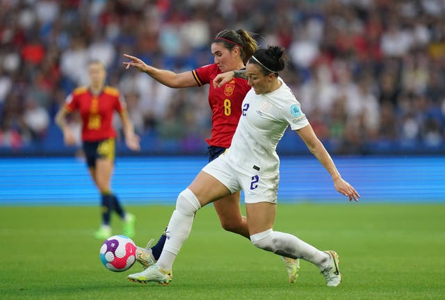 Lucy Bronze battles for possession with Spain’s Mariona Caldentey, left