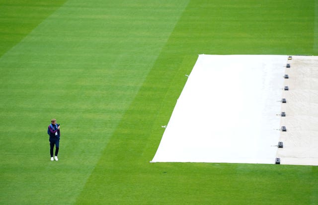 Ben Stokes surveys the sodden outfield at Emirates Old Trafford.