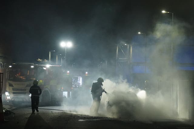 =Firefighters tend to a burning police car burns as officers are deployed on the streets of Hartlepool following a violent protest