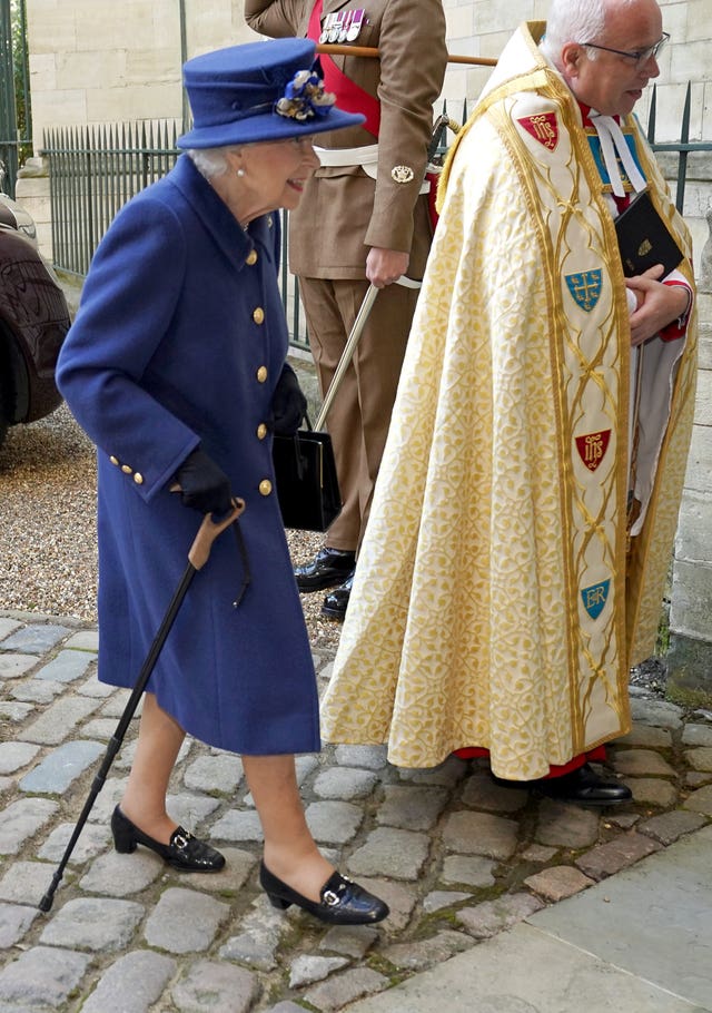 The Queen uses a walking stick as she arrives at Westminster Abbey