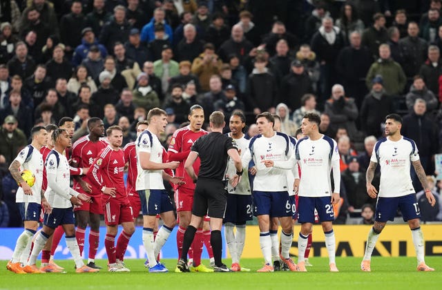 Cristian Romero leaves the pitch after being shown a red card 