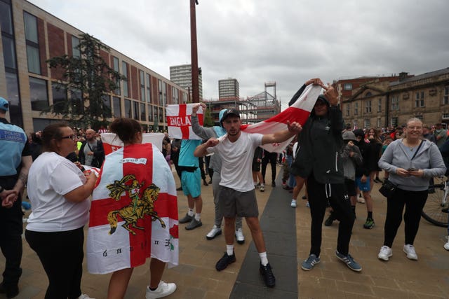 Protesters wrapped in Union flags