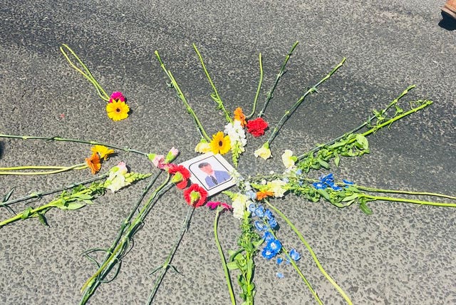 Flowers laid by the family and friends of Barnaby Webber at the scene on Ilkeston Road where he was killed