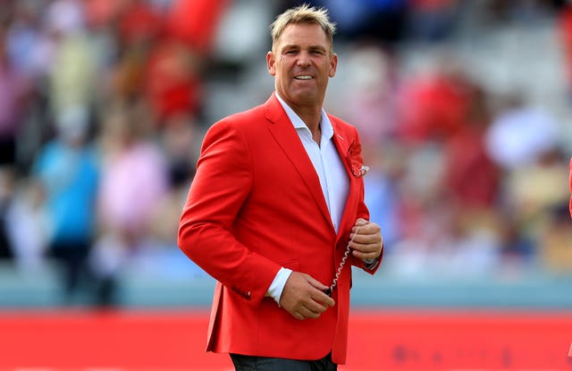 Australian pundit Shane Warne wearing a red blazer on the Lord's pitch