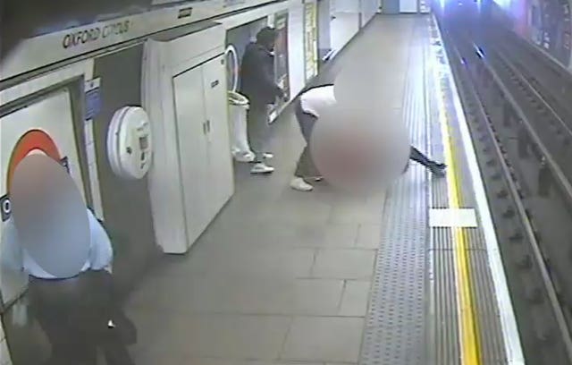 CCTV still of blurred out people on the platform at Oxford Circus station