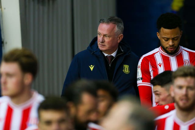 Michael O'Neill emerges from the tunnel with his Stoke players