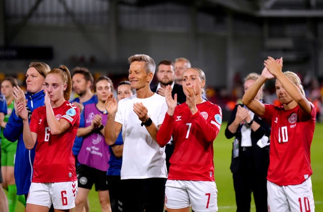 Denmark head coach Lars Sondergaard and his players applaud the fans after their defeat to Spain 