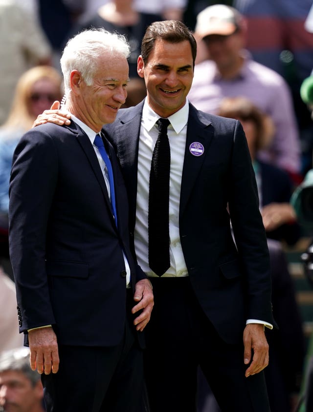 Former Wimbledon champions John McEnroe (left) and Roger Federer 