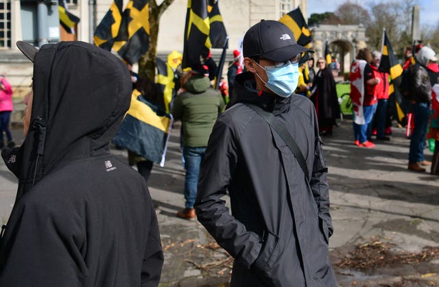 People wearing face masks ahead of the St David’s Day Parade in Cardiff (Ben Birchall/PA)