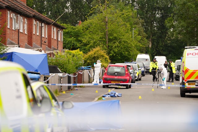 Forensic officers near a property in Barnard Road in Gorton, Manchester 