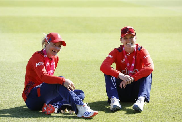Danni Wyatt-Hodge and Amy Jones sit on the outfield