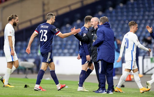 Steve Clarke, third right, shakes hands with Andy Considine after the game