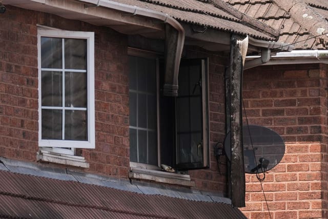 View of a window blackened and damaged by fire