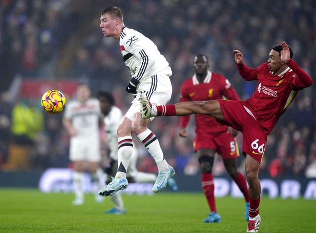 Liverpool's Trent Alexander-Arnold, right, battles for the ball with Manchester United's Rasmus Hojlund